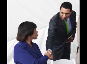 Prime Minister Portia Simpson Miller is greeted by Opposition Leader Andrew Holness during yesterday's signing of the Political Code of Conduct at Emancipation Park in New Kingston. (Photo: Gleaner)